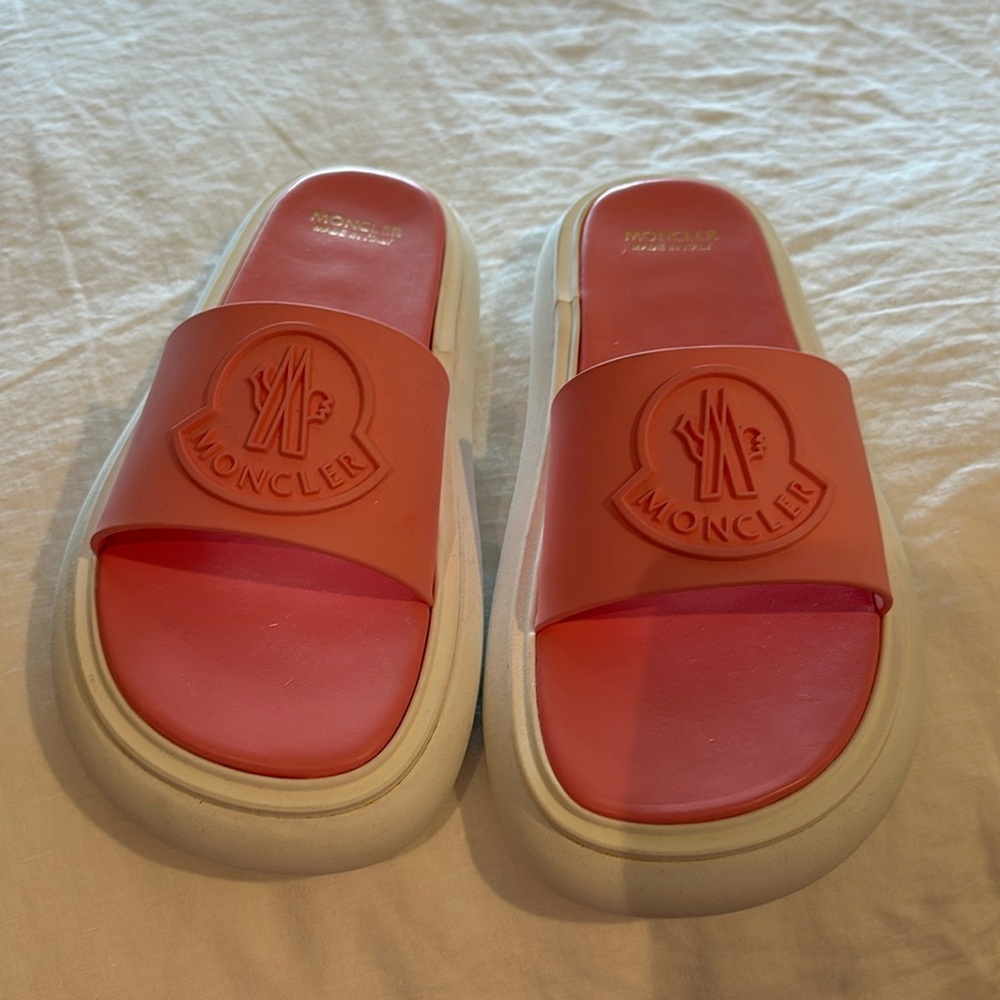 Pink Monclair slides in a size 9. Never been warm.